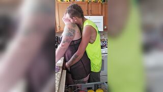 Husband sneaks in on wife doing dishes